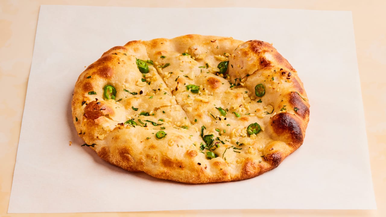100. Red chilli or green chilli garlic Naan